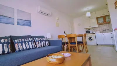 a living room with a blue couch and a table at STAY Camelia Apartment in Larnaka