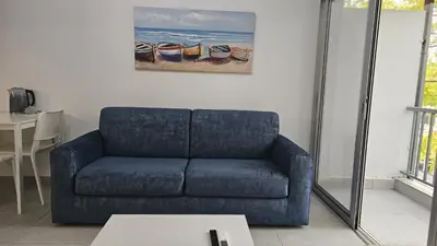 a blue couch in a living room with a table at STAY Historia Apartment in Nicosia