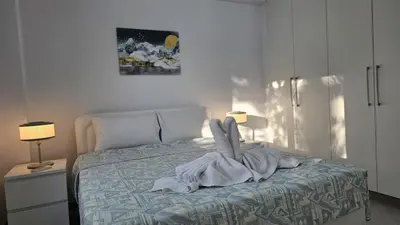 a bedroom with a bed with a towel on it at STAY Historia Apartment in Nicosia