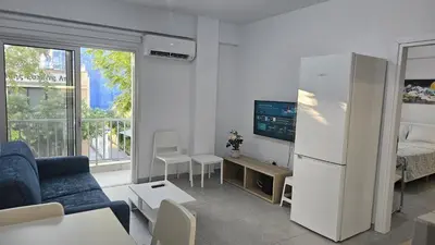 a living room with a couch and a refrigerator at STAY Historia Apartment in Nicosia