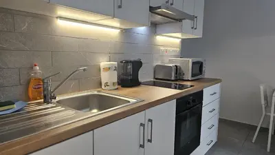 a kitchen with a sink and a microwave at STAY Historia Apartment in Nicosia