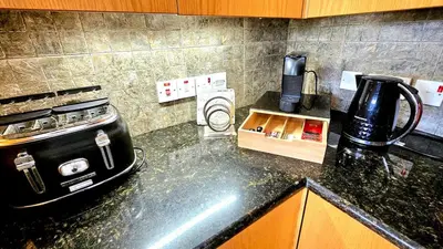 a kitchen counter with a coffee maker and a stove at Suburban Family Villa in Limassol