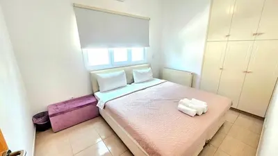 a small bedroom with a bed with two towels on it at Suburban Family Villa in Limassol