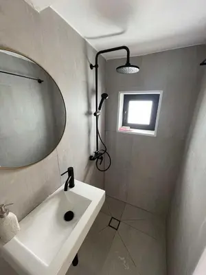 a bathroom with a sink and a mirror at The Hideaway in Arminou