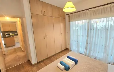 a living room with two towels on a rug at Neapolis city apartment in Limassol