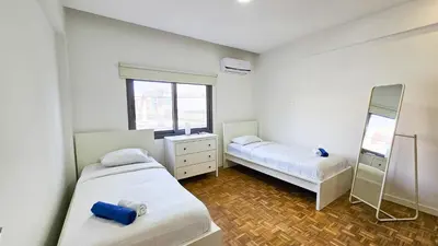 a small room with two beds and a mirror at The Cozy Seaside Retreat in Larnaka