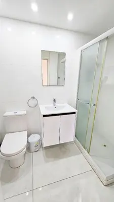 a bathroom with a toilet and a sink and a shower at The Cozy Seaside Retreat in Larnaka