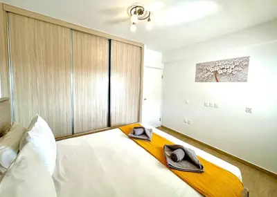 a bedroom with a bed with two hats on it at Central Napa Escape - Adults Only in Ayia Napa