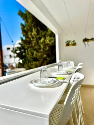 a white table with white chairs and glasses on it at Central Napa Escape - Adults Only in Ayia Napa