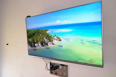 a flat screen tv hanging on a wall at Modern Larnaca Beach Apartment in Larnaka