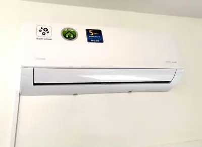 a white refrigerator with two stickers on it at Modern Larnaca Beach Apartment in Larnaka