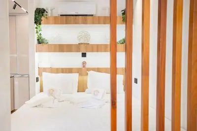 a bedroom with a bunk bed with white sheets at SuiteNapa22 in Ayia Napa