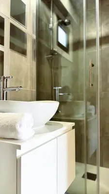 a bathroom with a sink and a glass shower at City Centre 2-Bedroom, Old Town, Nicosia in Nicosia