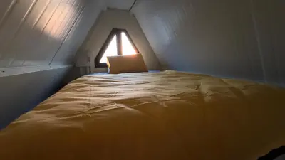 a bed in a small room with a window at Garden Cottage Cyprus in Ayia Napa