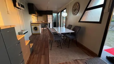 a kitchen and dining room with a table and chairs at Garden Cottage Cyprus in Ayia Napa