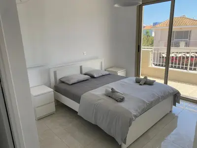 a bedroom with a bed and a large window at Mimosa 18 Beachhouse Villa in Protaras