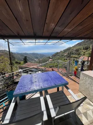 a blue picnic table on a deck with a view at Odou Off-grid in Odhou