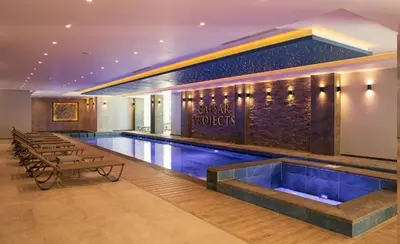 a swimming pool in a building with a swimming pool at CEASAR RESORT STUDIO Consus in Aglantzia