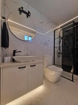 a bathroom with a sink and a toilet and a mirror at Modern House in Touristic Pyla - Oroklini! in Larnaka