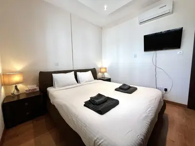 a bedroom with a bed with two towels on it at STAY Mesa Luxe Apartment in Limassol