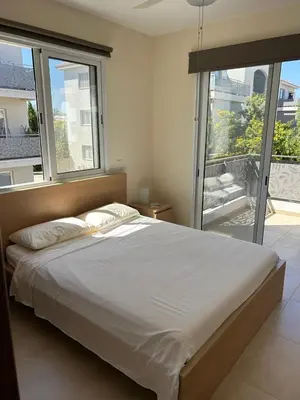 a bedroom with a large bed with a large window at Cozy 2-Bedroom Beach Flat in Paralimni