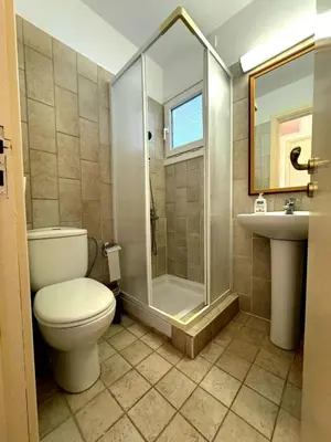 a bathroom with a toilet and a shower and a sink at Serenity Pool & Garden Villa in Limassol