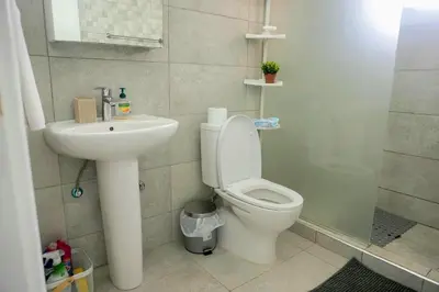a bathroom with a toilet and a sink at Kapparis Avenue Beach Apartment in Paralimni