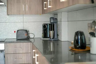 a kitchen with a counter top with a coffee maker at Kapparis Avenue Beach Apartment in Paralimni