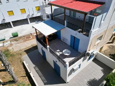 an overhead view of a white building with a red roof at Kapparis Avenue Beach Apartment in Paralimni
