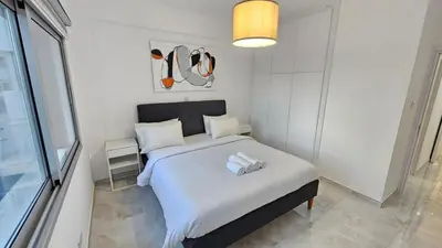 a bedroom with a bed with two towels on it at Sea Breeze 3 Bed Frontline Flat in Limassol