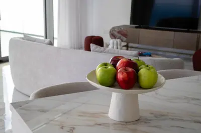 a plate of apples sitting on a table at Trilogy Limassol Seafront in Limassol