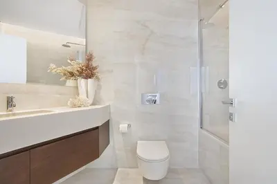 a bathroom with a shower and a toilet and a sink at Trilogy Limassol Seafront in Limassol