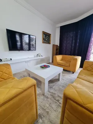 a living room with two chairs and a white table at At Patara Site, the heart of Kyrenia in Aglantzia