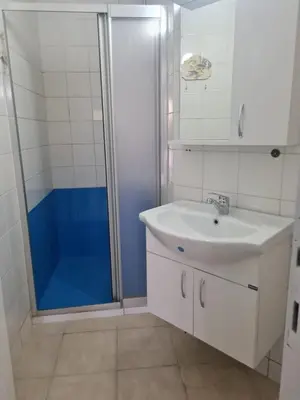 a bathroom with a sink and a glass shower at At Patara Site, the heart of Kyrenia in Aglantzia