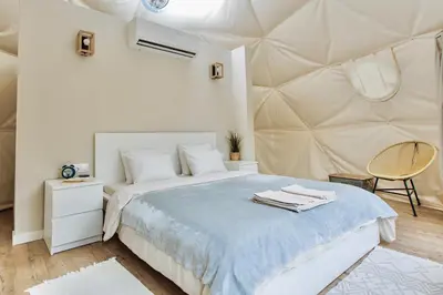 a bedroom with a bed with a blue blanket at Geometry Park in Ayios Theodhoros