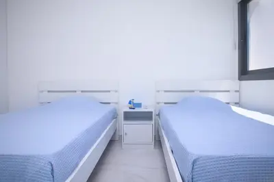 two beds sitting next to each other in a bedroom at Elegant penthouse in City Centre in Larnaka