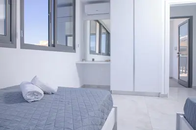 a bedroom with a bed with two pillows on it at Elegant penthouse in City Centre in Larnaka