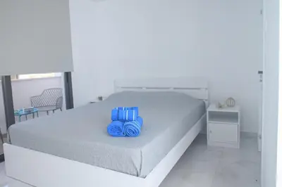 a bedroom with a bed with blue objects on it at Elegant penthouse in City Centre in Larnaka
