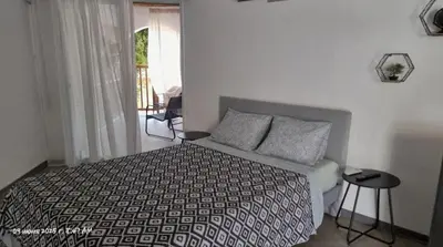 a bedroom with a bed and a window at Paradise Garden Sweet Studio in Limassol