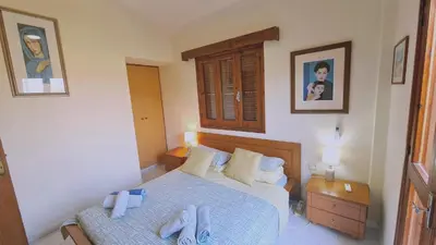 a bedroom with two beds with towels on them at STAY Villa Michalis in Pissouri