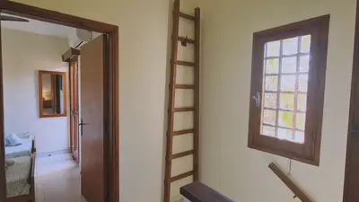 a room with a ladder next to a window at STAY Villa Michalis in Pissouri