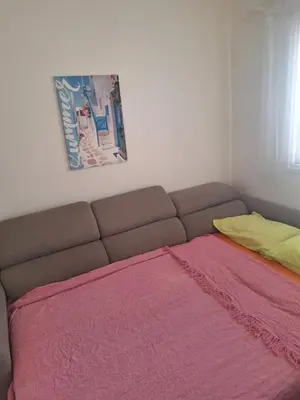 a bed in a room with a pink blanket at Easy 2 bedroom apartment, Makenzi beach in Larnaka