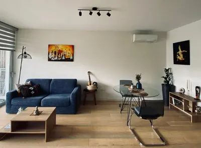 a living room with a blue couch and a table at Stylish Apt near UNIC Medical School & EUC in Engomi
