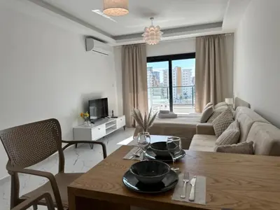 a living room with a table and a couch at Marcellus in Larnaka