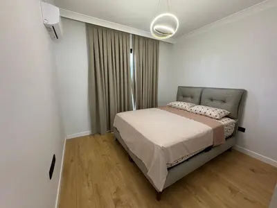 a bedroom with a bed in a white room at Kervansaray Comfort in Ayii Trimithias
