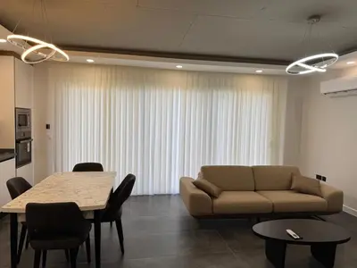a living room with a couch and a table at Kervansaray Comfort in Ayii Trimithias