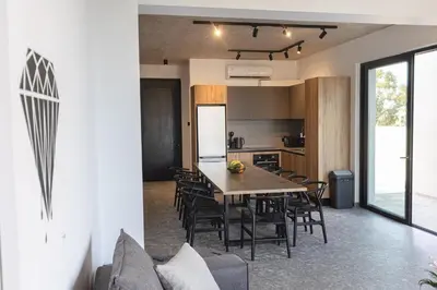 an open kitchen and dining room with a table and chairs at Black Diamond Villas Protaras in Protaras