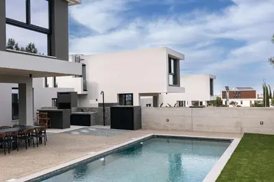 a house with a swimming pool in the backyard at Black Diamond Villas Protaras in Protaras