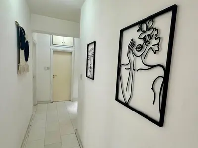 a hallway with two framed pictures on a wall at 2 bedrooms flat near center in Engomi