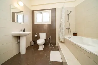 a bathroom with a sink and a toilet and a bath tub at 2 bedroom flat in Nicosia